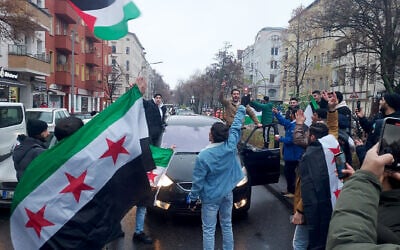 Members of the Syrian community wave Syrian flags in Berlin, Germany, and celebrate the end of Syrian dictator Bashar al-Assad's rule after rebel fighters took control of the Syrian capital Damascus on December 8, 2024. (Frank ZELLER / AFP)