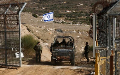An Israeli military vehicle crosses the fence, returning from the buffer zone with Syria, near the Druze village of Majdal Shams in the Golan Heights, on December 10, 2024. (Jalaa MAREY / AFP)