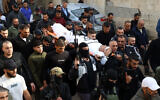 Mourners carry the body of 19-year-old Rahbi Shalabi, who was killed during clashes between Palestinian Authority security forces and local terror groups a day earlier, during his funeral in the West Bank city of Jenin on December 10, 2024. (Zain Jaafar/AFP)