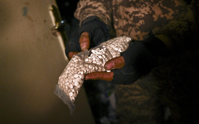 A Syrian rebel fighter holds a bag containing pills of captagon found at Mazzeh Military Airport in the west of Damascus on December 12, 2024. (Aris Messinis/AFP) A Syrian rebel fighter holds a bag containing pills of captagon found at Mazzeh Military Airport in the west of Damascus on December 12, 2024. (Aris Messinis/AFP)