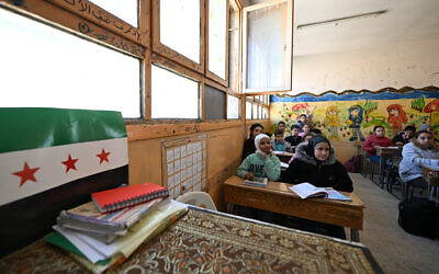 Syrian schoolchildren attend class at a school in the capital Damascus's Dweilaa neighborhood on December 15, 2024 (LOUAI BESHARA / AFP)