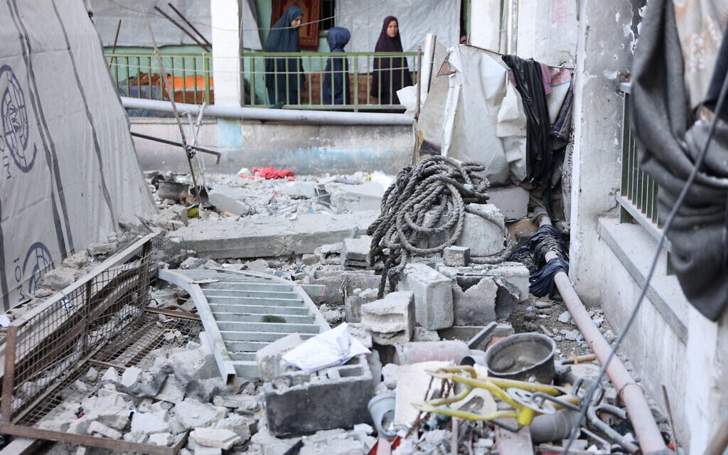People inspect the damage at the site of an Israeli strike that the IDF said targeted Hamas operatives embedded at the Musa Bin Nusair school in Gaza City on December 22, 2024 (Omar AL-QATTAA / AFP)