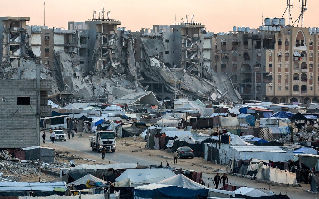 Tents sheltering displaced Palestinians are seen near destroyed buildings near the Hamad Residential City complex in the north of Khan Younis in the southern Gaza Strip, as Israel battles the Hamas terror group, December 22, 2024. (Bashar Taleb/AFP)