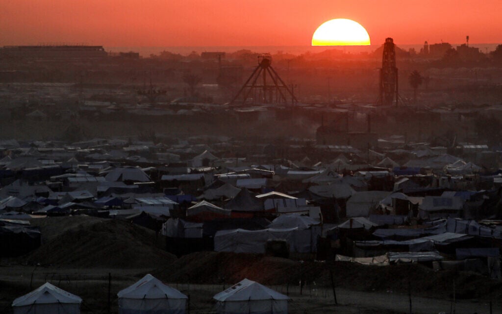 The sun sets behind tents sheltering Palestinians displaced by confict in the north of Khan Younis in the southern Gaza Strip on December 22, 2024 (Bashar TALEB / AFP)