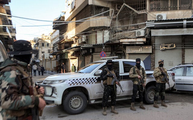Security forces deploy outside the Greek Orthodox Cathedral of St George during the Christmas morning mass in Syria's western coastal city of Latakia on December 25, 2024. (Photo by AAREF WATAD / AFP)