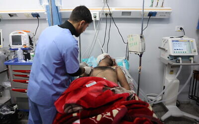 A wounded Palestinian receives medical attention at the Al-Shifa hospital in Gaza City, after patients were transported from the Kamal Adwan Hospital, on December 28, 2024, amid the ongoing war between Israel and the Hamas terror group. (Omar AL-QATTAA / AFP)