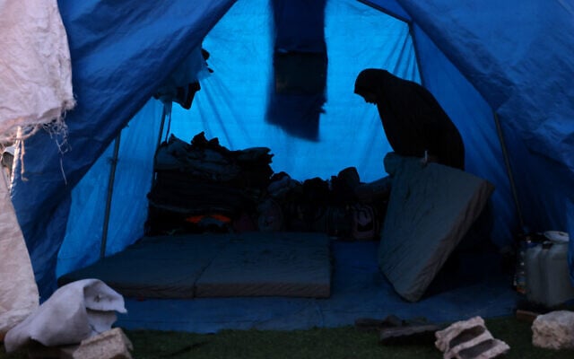 A woman prepares bedding inside a shelter at a camp for displaced Palestinians in Khan Younis, in the southern Gaza Strip on December 29, 2024. (Bashar Taleb/AFP) A woman prepares bedding inside a shelter at a camp for displaced Palestinians in Khan Younis, in the southern Gaza Strip on December 29, 2024. (Bashar Taleb/AFP)