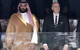 FILE - Saudi Arabia Crown Prince Mohammed bin Salman, left, and FIFA President Gianni Infantino, stand for the anthem prior to the match between Russia and Saudi Arabia which opened the 2018 soccer World Cup at the Luzhniki stadium in Moscow, Russia, on June 14, 2018. (Alexei Nikolsky, Sputnik, Kremlin Pool Photo via AP, File)