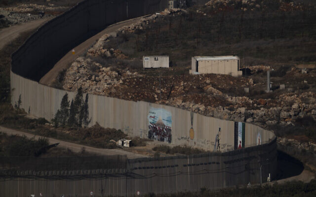 A wall marks the Israeli-Lebanese border near the village of Odaisseh in southern Lebanon, as seen from northern Israel, December 1, 2024. (AP Photo/Leo Correa)
