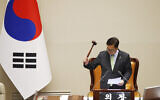 South Korean National Assembly Speaker Woo Won-shik bangs the gavel to announce that "the voting cannot take place" because the quorum was not reached during a plenary session for the impeachment vote of South Korean President Yoon Suk Yeol at the National Assembly in Seoul, South Korea, Saturday, Dec. 7, 2024. (Jeon Heon-kyun/Pool Photo via AP)