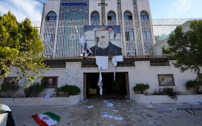 An Iranian flag lies on the ground at the entrance of the Iranian embassy which damaged by opposition fighters in Damascus, Syria, Dec. 8, 2024. (AP/Hussein Malla)