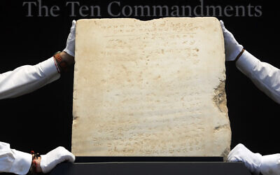 The oldest complete tablet of the Ten Commandments, weighing 115-pounds and approximately 1,500 years old, is displayed at Sotheby's, in New York, December 9, 2024. (Richard Drew/AP)