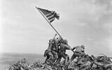 US Marines of the 28th Regiment, 5th Division, raise a US flag atop Mount Suribachi, Iwo Jima, Japan, Feb. 23, 1945. (AP Photo/Joe Rosenthal, File)