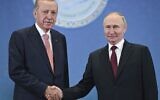 Russian President Vladimir Putin, right, and Turkish President Recep Tayyip Erdogan shake hands as they pose for photos during a meeting on the sidelines of the Shanghai Cooperation Organization summit in Astana, Kazakhstan, on July 3, 2024. (Sergey Guneyev, Sputnik, Kremlin Pool Photo via AP, File)
