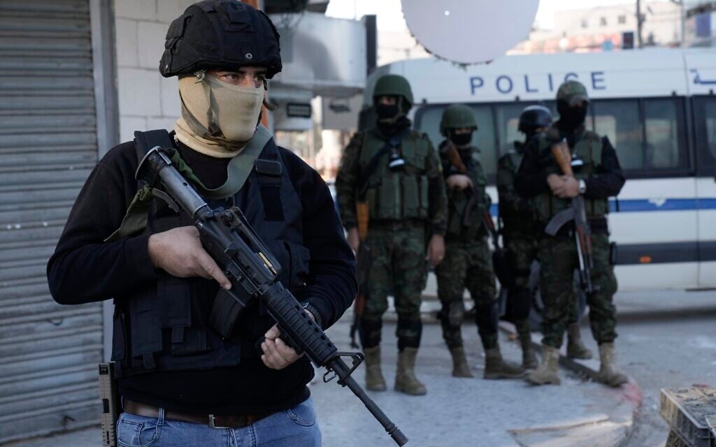 A Palestinian Authority security officer clutches his gun amid a major raid against members of terror groups in the Jenin refugee camp in the West Bank, December 16, 2024. (AP Photo/Majdi Mohammed) A Palestinian Authority security officer clutches his gun amid a major raid against members of terror groups in the Jenin refugee camp in the West Bank, December 16, 2024. (AP Photo/Majdi Mohammed)