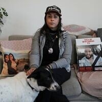 Released hostage Ilana Gritzewsky poses for a portrait in her apartment in Kiryat Gat, December 15, 2024, near photos of her boyfriend, Matan Zangauker, who is being held hostage by Hamas in the Gaza Strip. (AP Photo/Tsafrir Abayov)