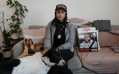 Released hostage Ilana Gritzewsky poses for a portrait in her apartment in Kiryat Gat, December 15, 2024, near photos of her boyfriend, Matan Zangauker, who is being held hostage by Hamas in the Gaza Strip. (AP Photo/Tsafrir Abayov)
