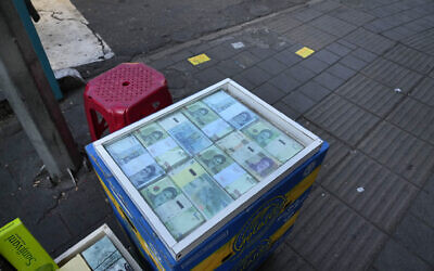 Iranian banknotes are displayed by a street money exchanger at Ferdowsi square, Tehran's go-to venue for foreign currency exchange, in downtown Tehran, Iran, December 18, 2024. (AP Photo/Vahid Salemi)