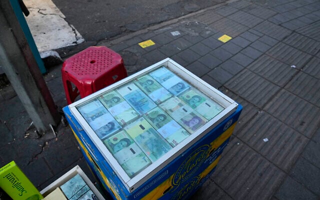 Iranian banknotes are displayed by a street money exchanger at Ferdowsi square, Tehran's go-to venue for foreign currency exchange, in downtown Tehran, Iran, December 18, 2024. (AP Photo/Vahid Salemi) Iranian banknotes are displayed by a street money exchanger at Ferdowsi square, Tehran's go-to venue for foreign currency exchange, in downtown Tehran, Iran, December 18, 2024. (AP Photo/Vahid Salemi)