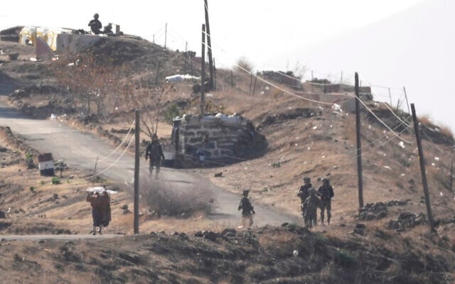 A Syrian man, left, waves a white flag as he approaches Israeli soldiers to speak to them at a position at an abandoned Syrian military base, in Maariyah village near the border with Israel, in southern Syria, Dec. 19, 2024. (AP/Hussein Malla) A Syrian man, left, waves a white flag as he approaches Israeli soldiers to speak to them at a position at an abandoned Syrian military base, in Maariyah village near the border with Israel, in southern Syria, Dec. 19, 2024. (AP/Hussein Malla)