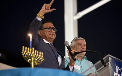 Jacob Monty joins Rabbi Peter Tarlow at the podium during a 'Chicanukah' event at Holocaust Museum Houston on Thursday, December 19, 2024, in Houston. (AP Photo/Annie Mulligan)
