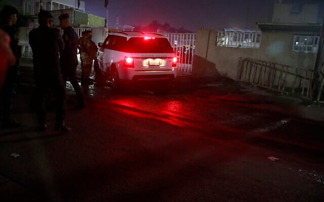 Iraqi security forces gather outside a morgue of Sheikh Zayed Hospital in Baghdad, Iraq, Nov. 7, 2022, where a US citizen who worked for an international aid organization was taken after he was fatally shot. (AP Photo/Hadi Mizban)