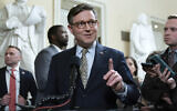 Speaker of the House Mike Johnson talks to reporters after passing the funding bill to avert the government shutdown at the Capitol in Washington, Dec. 20, 2024. (AP Photo/Jose Luis Magana)