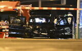Forensics work on a damaged car sitting with its doors open after a driver plowed into a busy Christmas market in Magdeburg, Germany, Dec. 21, 2024. (Hendrik Schmidt/dpa via AP)