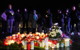 People light candles outside Magdeburg Cathedral after a memorial service for victims of Friday's Christmas Market attack, where a car drove into a crowd, in Magdeburg, Germany, December 21, 2024. (AP Photo/Ebrahim Noroozi)