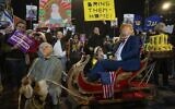 Demonstrators dressed as U.S. President-elect Donald Trump, right, and Prime Minister Benjamin Netanyahu, left, take part in a performance during a protest against the government and call for the release of hostages held in the Gaza Strip by the Hamas terrorist group, in Tel Aviv, December 21, 2024. (AP Photo/Ohad Zwigenberg)
