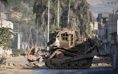Israeli military bulldozers are seen during a military raid in the Nur Shams refugee camp near the West Bank city of Tulkarem, December 24, 2024. (AP Photo/Majdi Mohammed)