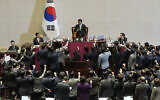 Lawmakers of the ruling People Power Party protest to South Korea's National Assembly Speaker Woo Won Shik, top center, during a plenary session for the impeachment motion against South Korean acting President Han Duck-soo at the National Assembly in Seoul, South Korea, December 27, 2024. (AP Photo/Ahn Young-joon)