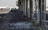 Workers walk past broken glass in Sanaa International Airport following Israeli airstrikes on Yemen the previous day, December 27, 2024. (AP Photo/Osamah Abdulrahman)