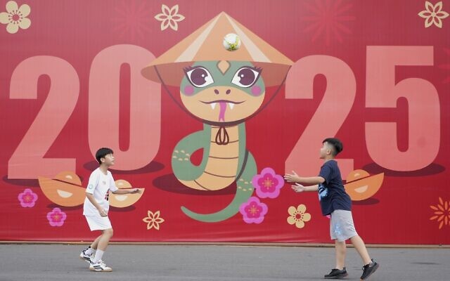 Two boys play football in front of a billboard welcoming the New Year 2025 in Ho Chi Minh city, Vietnam on Tuesday, Dec. 31, 2024. (AP Photo/Hau Dinh) Two boys play football in front of a billboard welcoming the New Year 2025 in Ho Chi Minh city, Vietnam on Tuesday, Dec. 31, 2024. (AP Photo/Hau Dinh)