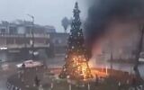 Screen capture from video of a Christmas tree that was set alight in the Christian-majority town of Suqaylabiyah, near Hama, Syria, December 24, 2024. (X. Used in accordance with Clause 27a of the Copyright Law)