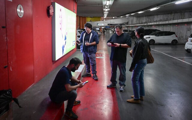 Israelis take cover inside a bomb shelter as sirens sound in Tel Aviv, December 16, 2024. (Avshalom Sassoni/Flash90) Israelis take cover inside a bomb shelter as sirens sound in Tel Aviv, December 16, 2024. (Avshalom Sassoni/Flash90)