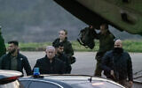 Benjamin Netanyahu, center, seen getting off a helicopter in Jerusalem on December 17, 2024. (Chaim Goldberg FLASH90)