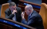 Prime Minister Benjamin Netanyahu, right, and Foreign Minister Gideon Sa'ar attend a plenum session on the state budget at the Knesset in Jerusalem, December 16, 2024. (Chaim Goldberg/Flash90)
