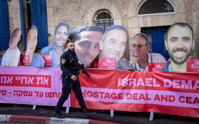 People protest for the release of Israeli hostages held in the Gaza Strip outside the home of Minister of Strategic Affairs Ron Dermer in Jerusalem, December 23, 2024. (Chaim Goldberg/Flash90)