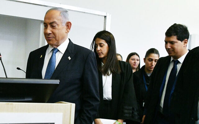Prime Minister Benjamin Netanyahu arrives at a courtroom in the Tel Aviv District Court before the start of his testimony on December 23, 2024 (Reuven Kastro/POOL)