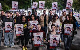 Family, friends and activists hold posters of Israeli brothers Gili and Ziv Berman, who are held hostage by the Hamas terror group in Gaza, during a protest march for their release in Tel Aviv, December 26, 2024. (Tomer Neuberg/Flash90)
