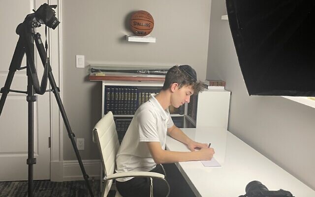 Hillel Kornwasser in his room in Teaneck, New Jersey, filming an opening scene for his documentary, 'Forces of Resilience.' (Courtesy)