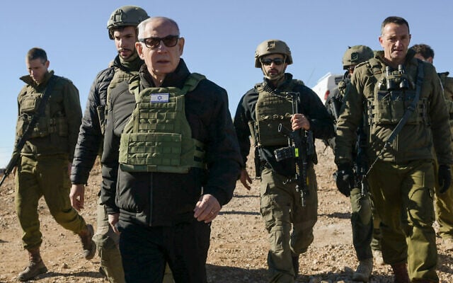 Prime Minister Benjamin Netanyahu visits the top of the Syrian side of Mount Hermon along with IDF Chief of Staff Herzi Halevi (right) and other troops, December 17, 2024. (Maayan Toaf/GPO)