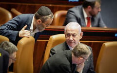 UTJ lawmaker Moshe Gafni, left, speaks to Prime Minister Benjamin Netanyahu in the Knesset on December 31, 2024. (Knesset Spokesperson)