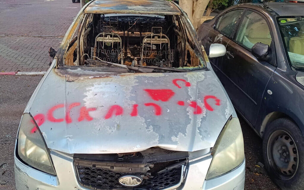 This image released by police on December 30, 2024, shows a car allegedly set on fire by Alexander Granovsky, a civilian recruited by 'foreign elements.' The graffiti on the car reads 'Children of Ruhollah.' (Israel Police)