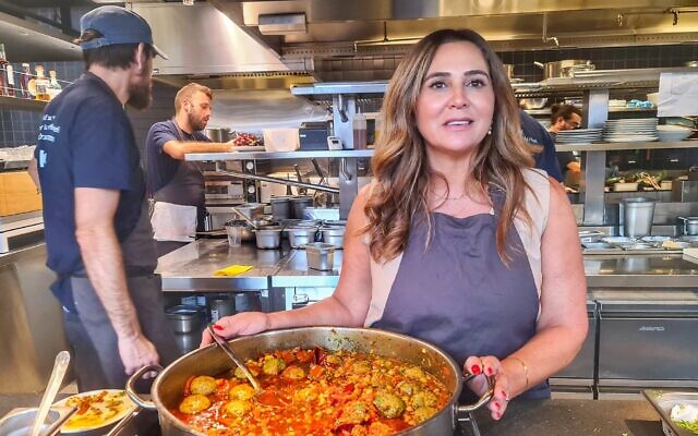 Sharona Dahan cooks at Asif in Tel Aviv, in a rare respite from takeout nearly a year after being evacuated from her home in Sderot, October 2024. (Deborah Danan)
