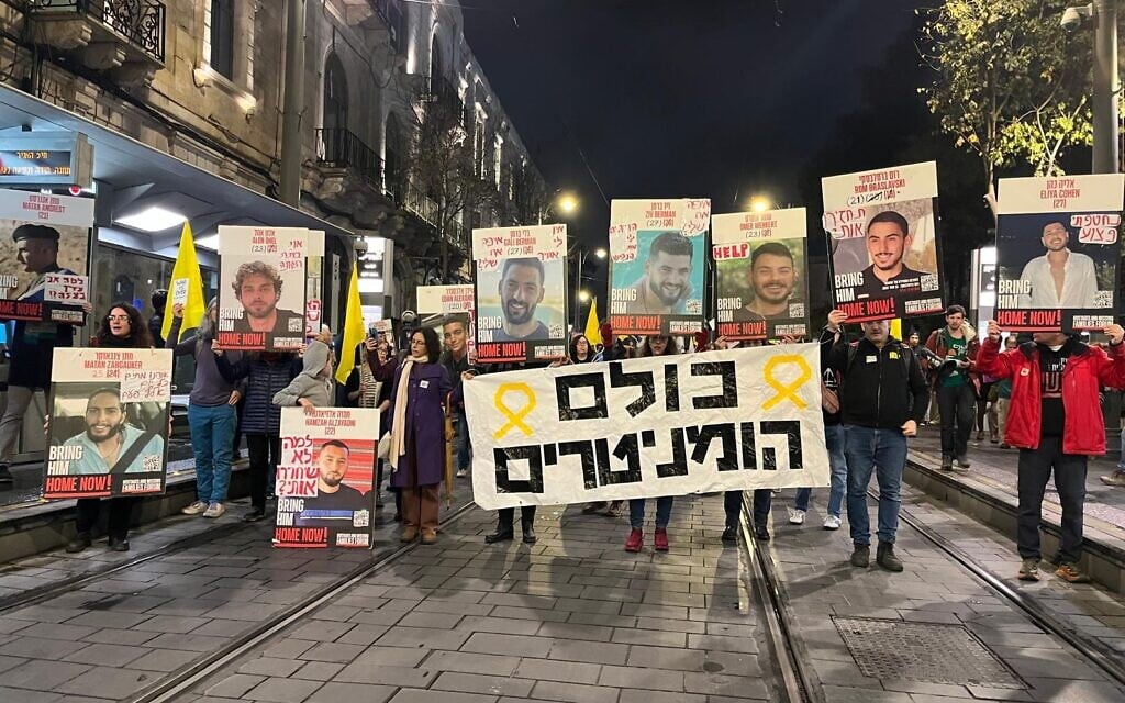 Protestors march from Safra Square in Jerusalem to Paris Square calling for the release of the hostages on December 21, 2024. Banner reads: "They are all humanitarian" in reference to the selection of which hostages will be returned in a hostage deal. (Orna Kupferman/protest movement)