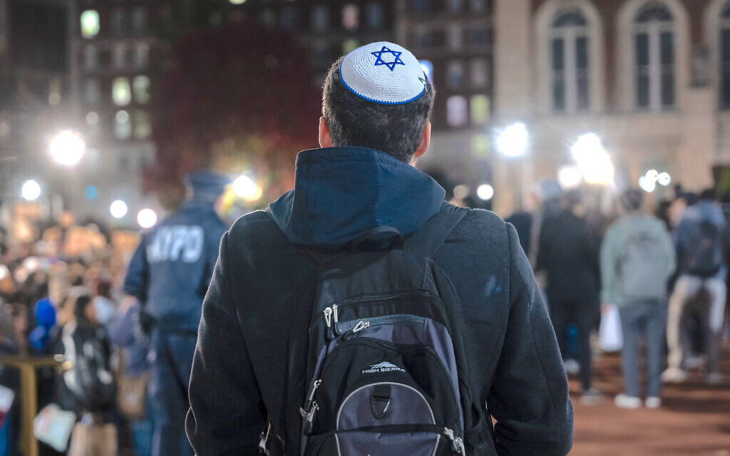 A Jewish student watches a protest in support of Palestinians at New York’s Columbia University campus, November 14, 2023. (Spencer Platt/Getty Images via JTA) A Jewish student watches a protest in support of Palestinians at New York’s Columbia University campus, November 14, 2023. (Spencer Platt/Getty Images via JTA)