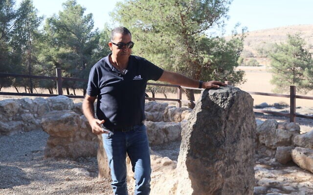 Archaeologist Saar Ganor stands by a pillar that held up the second story of a house in the Mirsham Farmhouse archaeological site. (Shmuel Bar-Am)