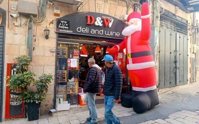 A liquor store decorated for Christmas in the Christian Quarter of the Jerusalem Old City, December 24, 2024 (Gianluca Pacchiani/Times of Israel)